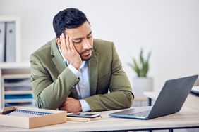 man falling asleep at his desk