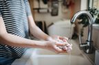 person washing hands to prevent a staph infection