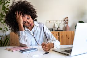 person sitting on table feeling stressed 