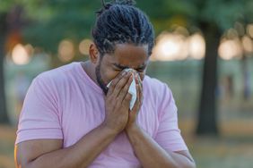 A man blows his nose