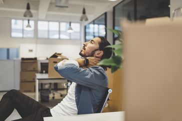 A man with neck pain from tech neck in the office