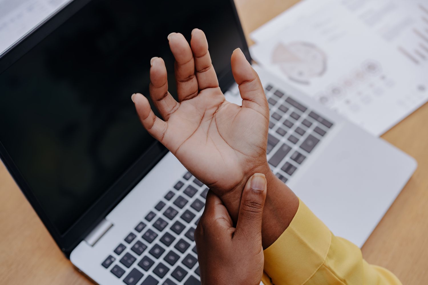 A woman with tendinitis touching her wrist