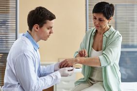 person with weeping eczema seeing dermatologist for treatment