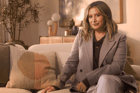 Ashley Tisdale sitting on a couch.